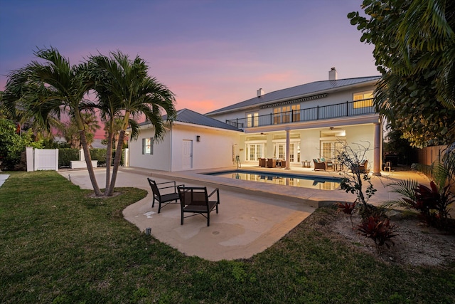 401 Center St, Jupiter, FL 33458 - back of house with a balcony, a patio, an outdoor pool, and an outdoor living space