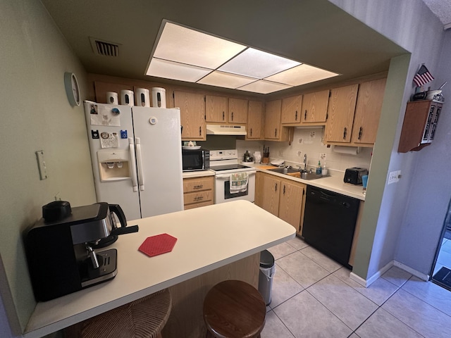 kitchen with sink, light tile patterned floors, and black appliances