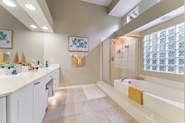 bathroom with tile patterned flooring, vanity, and separate shower and tub