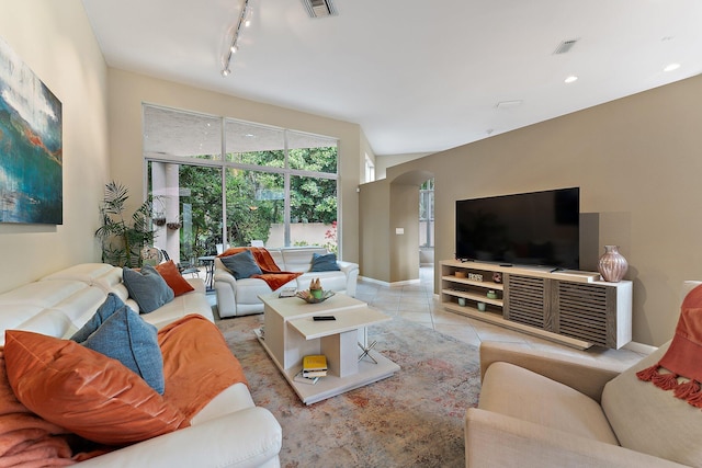 living room with light tile patterned floors and track lighting