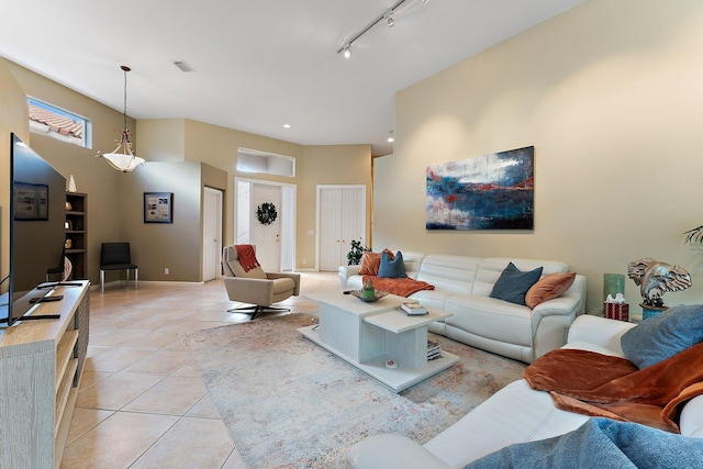 living room featuring light tile patterned floors and track lighting