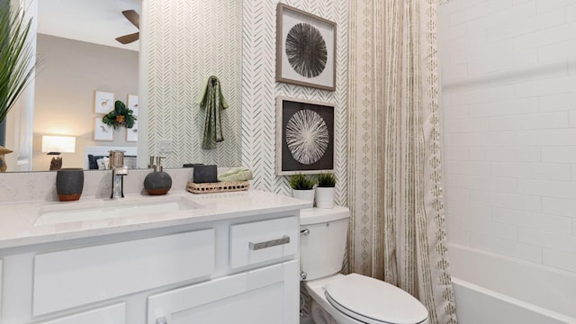 full bathroom featuring vanity, shower / bathtub combination with curtain, ceiling fan, and toilet