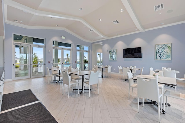 dining area featuring high vaulted ceiling, light hardwood / wood-style floors, and french doors