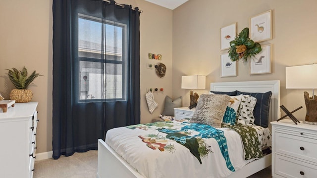 bedroom featuring multiple windows and light colored carpet