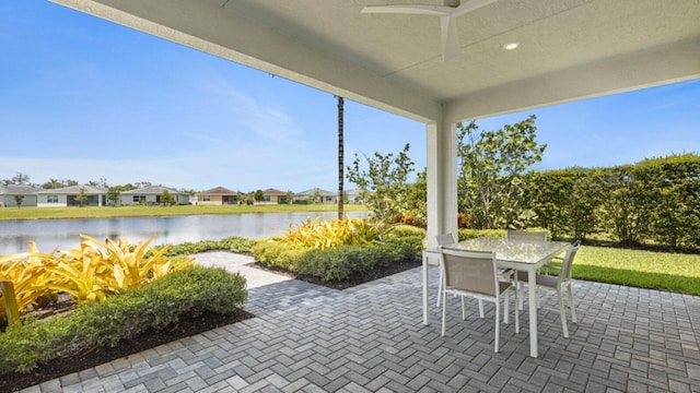 view of patio / terrace with ceiling fan and a water view