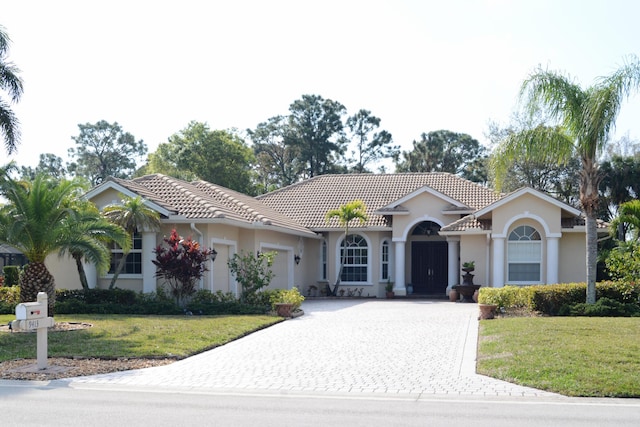 view of front of property with a garage and a front yard