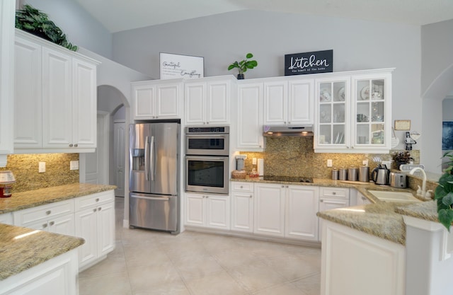 kitchen with sink, appliances with stainless steel finishes, tasteful backsplash, light stone countertops, and white cabinets