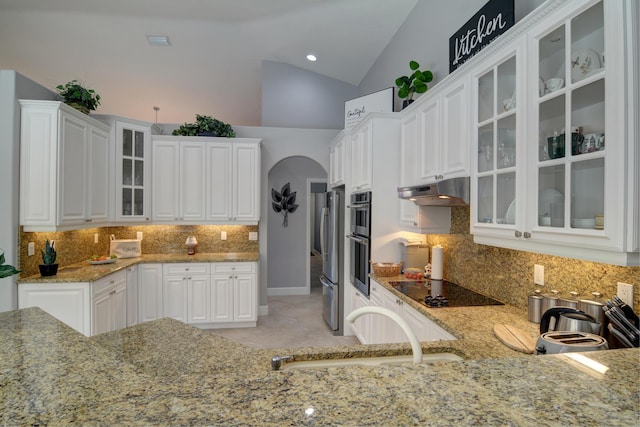 kitchen with white cabinetry, appliances with stainless steel finishes, sink, and light stone counters