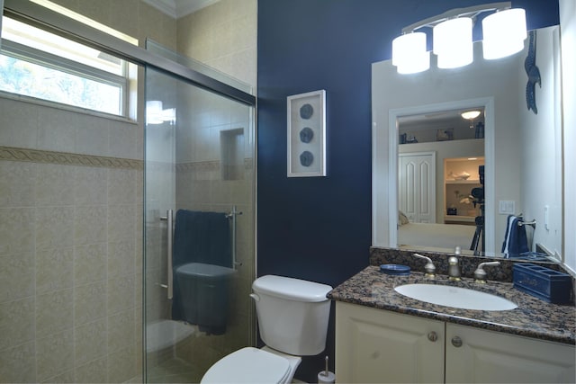 bathroom with vanity, an enclosed shower, and toilet