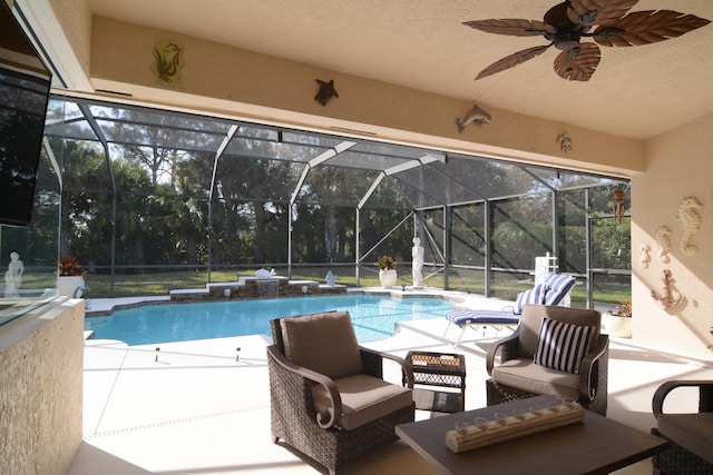 view of swimming pool featuring a patio, a lanai, and ceiling fan