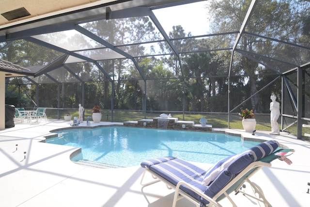 view of pool featuring pool water feature, a lanai, and a patio area