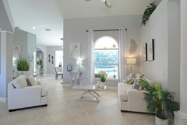 living room featuring light tile patterned floors and ceiling fan