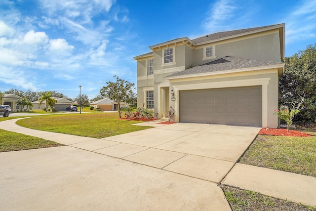 view of front of property featuring a garage and a front yard