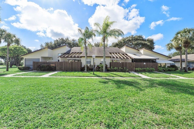 view of front of house with a garage and a front yard