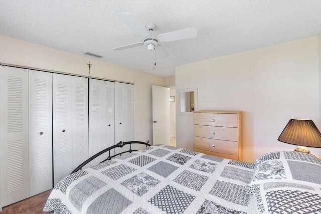 bedroom featuring ceiling fan, a closet, a textured ceiling, and carpet