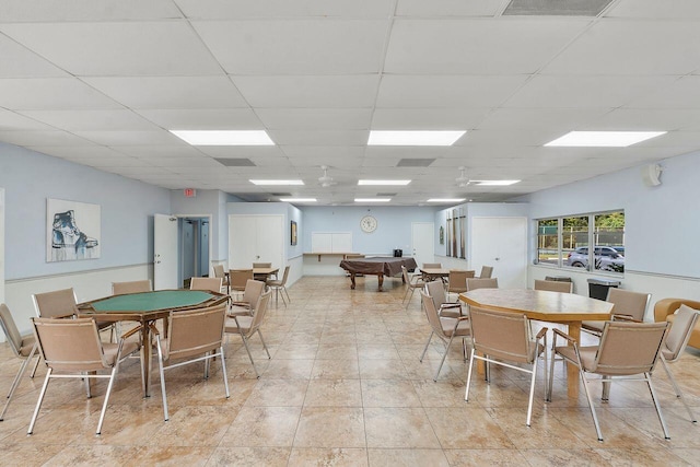 dining room featuring light tile patterned flooring and a paneled ceiling