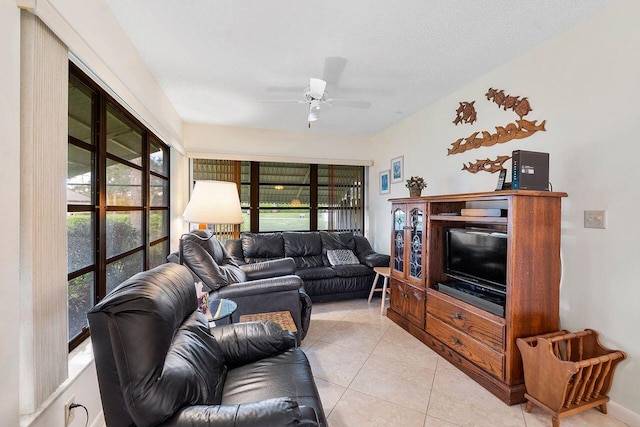 living room with light tile patterned floors, plenty of natural light, a textured ceiling, and ceiling fan