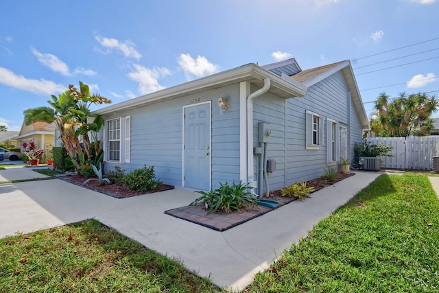 exterior space featuring a lawn and central air condition unit