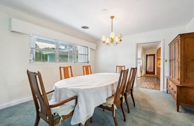 1531 Bacom Point Rd, Pahokee, FL 33476 - carpeted dining room featuring a chandelier and baseboards