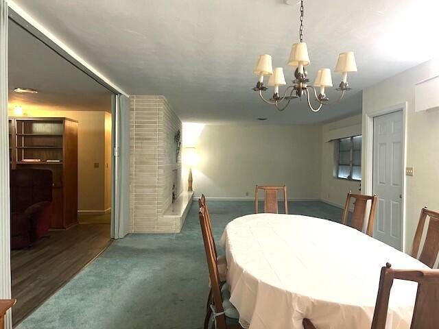 dining space featuring a chandelier and dark colored carpet