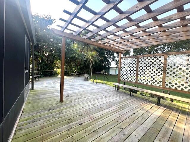 wooden deck featuring a pergola