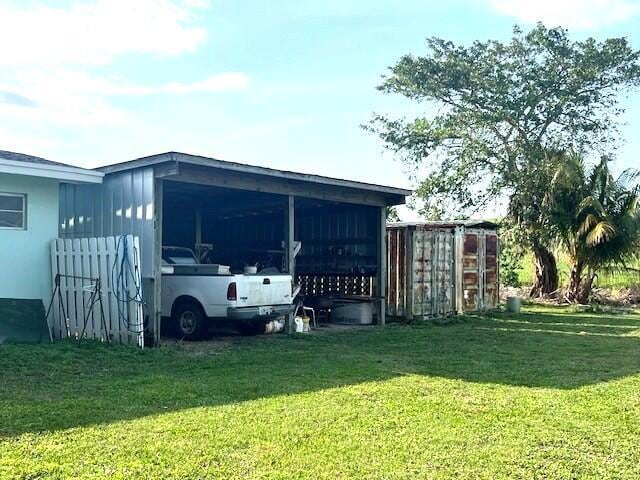 view of outbuilding with a yard