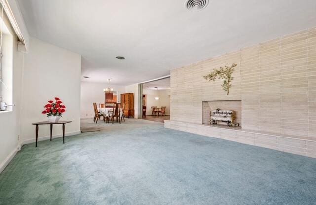 1531 Bacom Point Rd, Pahokee, FL 33476 - living area featuring carpet flooring, a chandelier, and a tiled fireplace