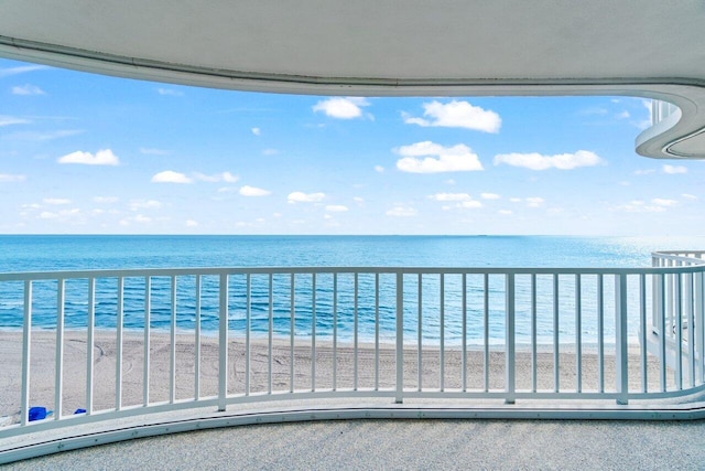 balcony featuring a beach view and a water view