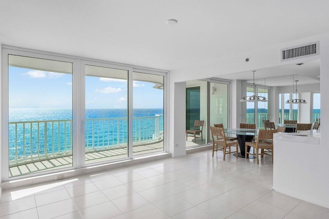 3211 S Ocean Blvd Unit 802, Highland Beach, FL 33487 - living area featuring floor to ceiling windows, light tile patterned floors, a water view, and a chandelier