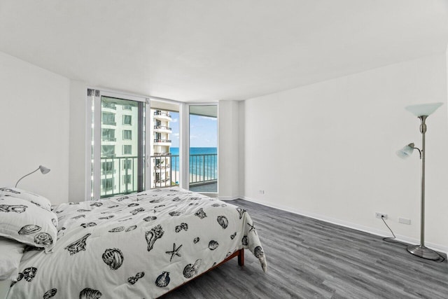 3211 S Ocean Blvd Unit 802, Highland Beach, FL 33487 - bedroom featuring wood finished floors, access to outside, baseboards, a water view, and a wall of windows