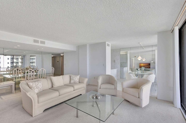 living room with light carpet and a textured ceiling