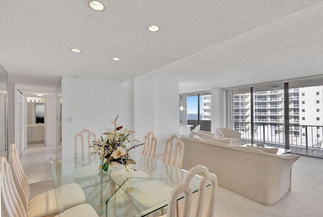 dining room featuring light tile patterned flooring and a textured ceiling