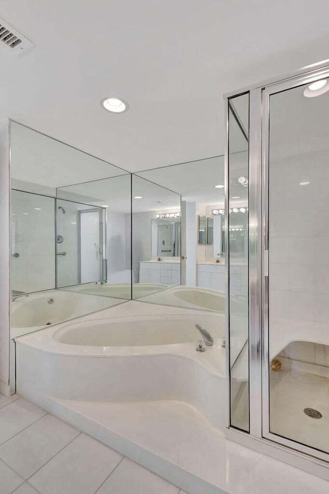 bathroom with shower with separate bathtub and tile patterned floors