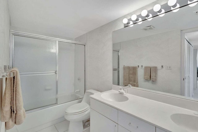 full bathroom with shower / bath combination with glass door, vanity, toilet, and tile patterned flooring