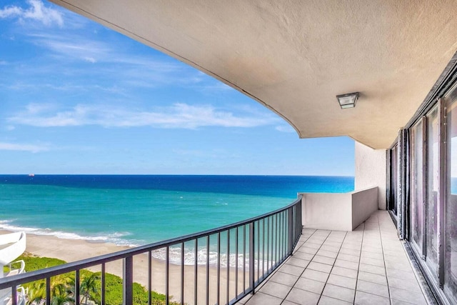 balcony featuring a water view and a view of the beach