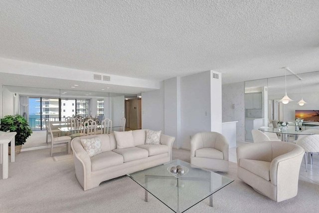 carpeted living room featuring a textured ceiling