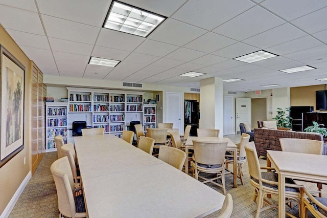 dining room with a drop ceiling