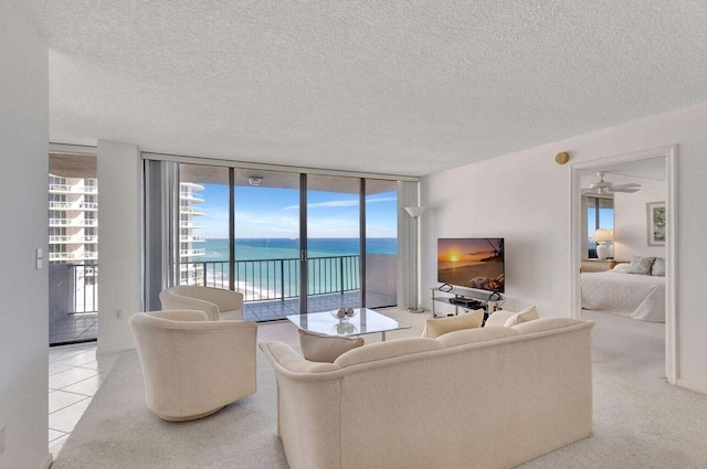 tiled living room with expansive windows and a textured ceiling