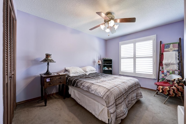 carpeted bedroom featuring ceiling fan, a closet, and a textured ceiling