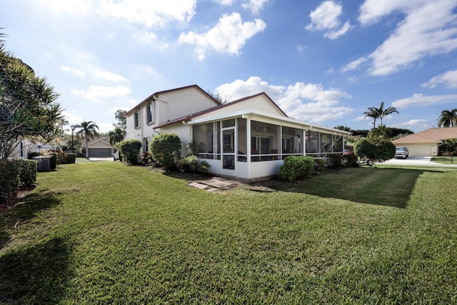 view of home's exterior featuring central AC, a yard, and a sunroom