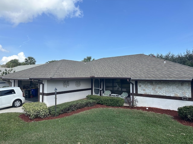 ranch-style home with a front lawn