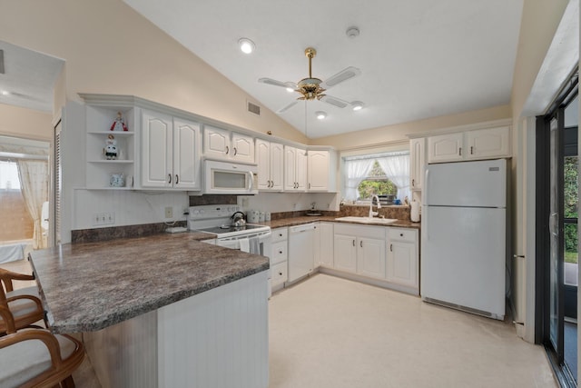 kitchen with dark countertops, a peninsula, white appliances, white cabinetry, and open shelves