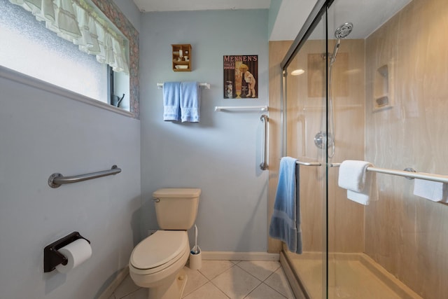 full bathroom featuring toilet, baseboards, a stall shower, and tile patterned floors