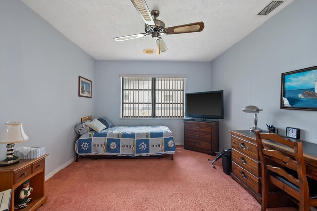 carpeted bedroom with a textured ceiling, a ceiling fan, visible vents, and baseboards