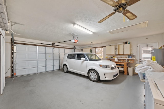 garage with washer and dryer, a garage door opener, and water heater