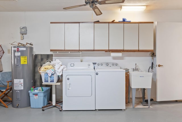 clothes washing area with washing machine and clothes dryer, ceiling fan, cabinet space, and water heater