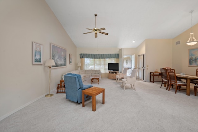 living area with light colored carpet, visible vents, baseboards, high vaulted ceiling, and ceiling fan