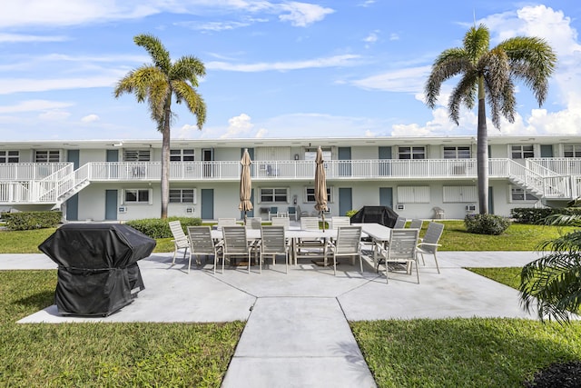 view of home's community featuring a yard and a patio area