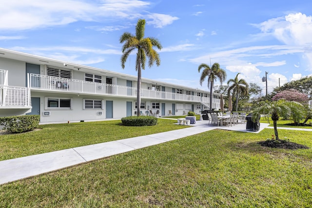 surrounding community with a patio and a lawn