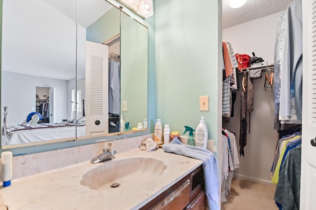 bathroom with vanity and a textured ceiling